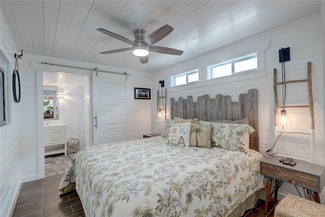 4034 Laguna Shores Rd, Corpus Christi, TX 78418 - bedroom with a barn door, wood ceiling, ensuite bath, ceiling fan, and dark wood-style flooring