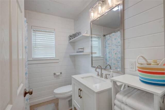 4034 Laguna Shores Rd, Corpus Christi, TX 78418 - full bathroom featuring toilet, wood walls, and vanity