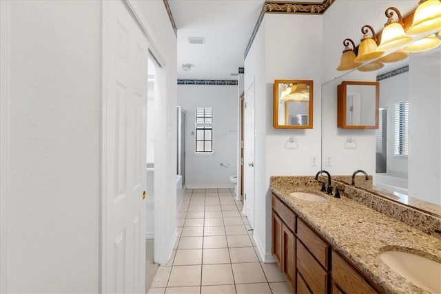 bathroom with tile patterned floors, plenty of natural light, toilet, and vanity