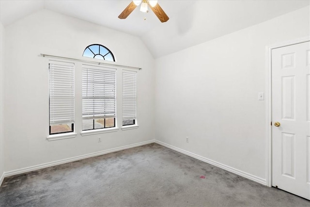 carpeted empty room featuring ceiling fan and vaulted ceiling