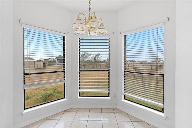 unfurnished dining area with a notable chandelier and light tile patterned floors