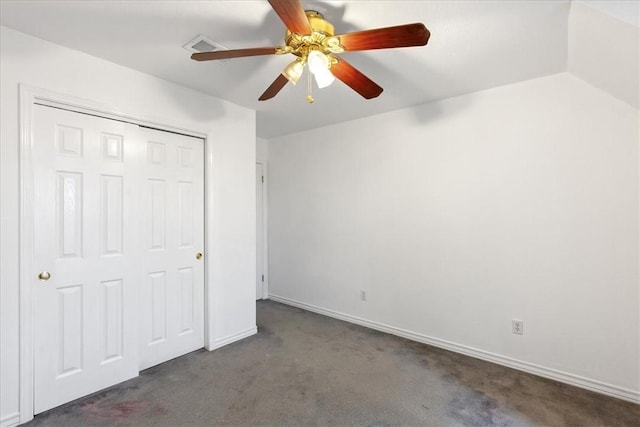 unfurnished bedroom with dark colored carpet, ceiling fan, and a closet