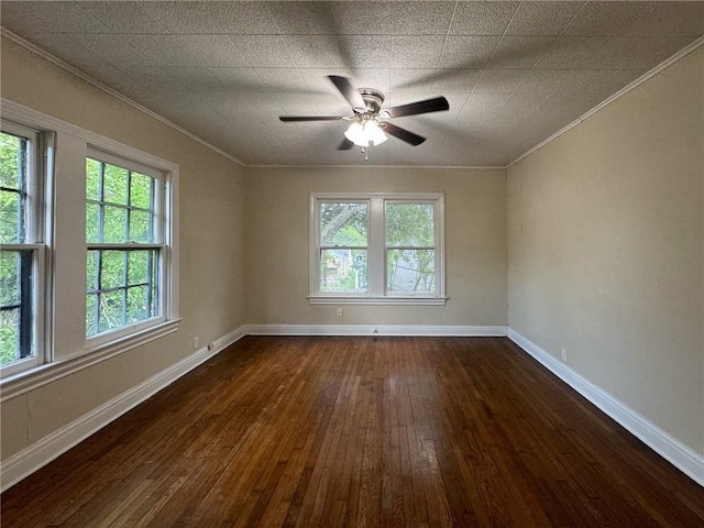 empty room featuring ceiling fan, dark hardwood / wood-style floors, and ornamental molding