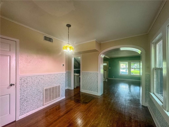 unfurnished dining area with dark hardwood / wood-style floors and ornamental molding