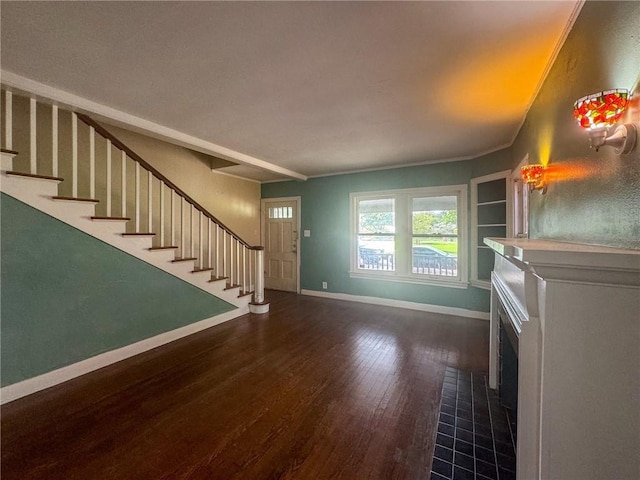 unfurnished living room featuring dark wood-type flooring and a tile fireplace