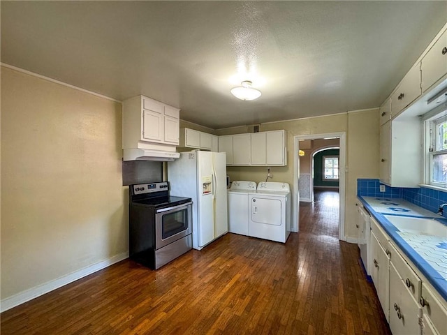 kitchen featuring washer and clothes dryer, white appliances, dark wood-type flooring, white cabinets, and sink