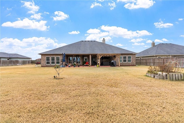 rear view of house featuring a lawn