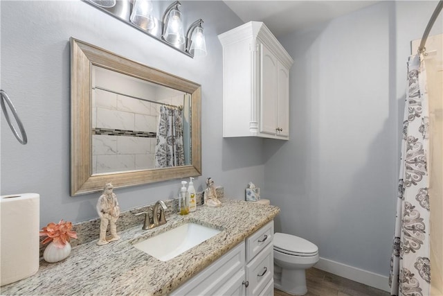 bathroom featuring hardwood / wood-style flooring, vanity, toilet, and walk in shower