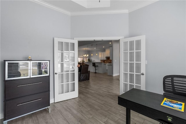 home office with ornamental molding, wood-type flooring, and french doors