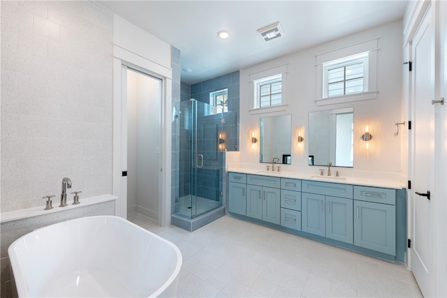 bathroom featuring vanity and shower with separate bathtub