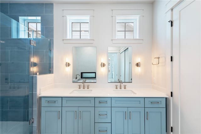 bathroom featuring vanity, an enclosed shower, and a healthy amount of sunlight