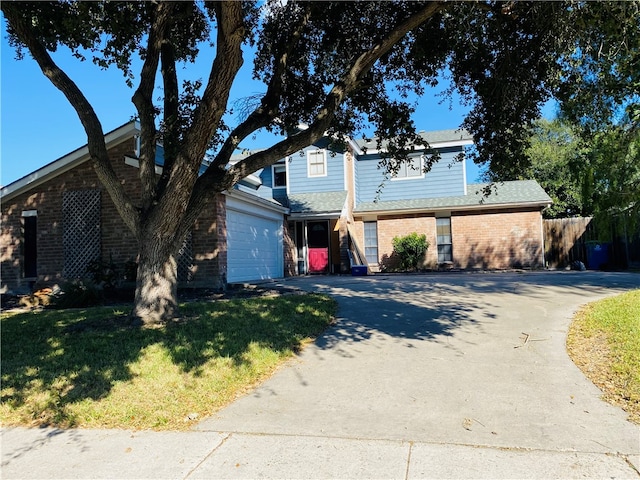 view of front of house with a garage and a front lawn