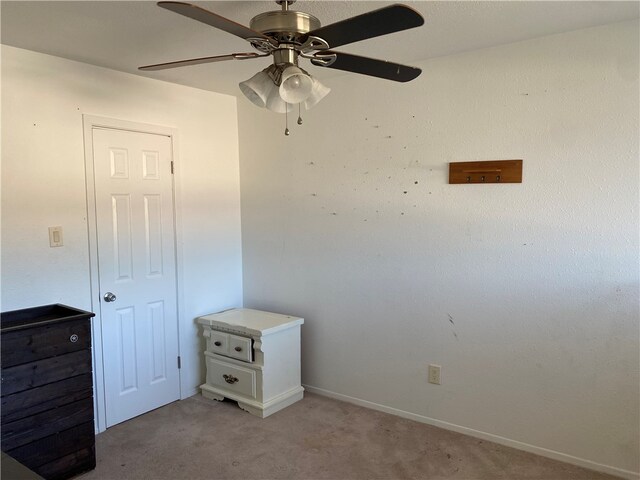 unfurnished bedroom featuring light carpet and ceiling fan