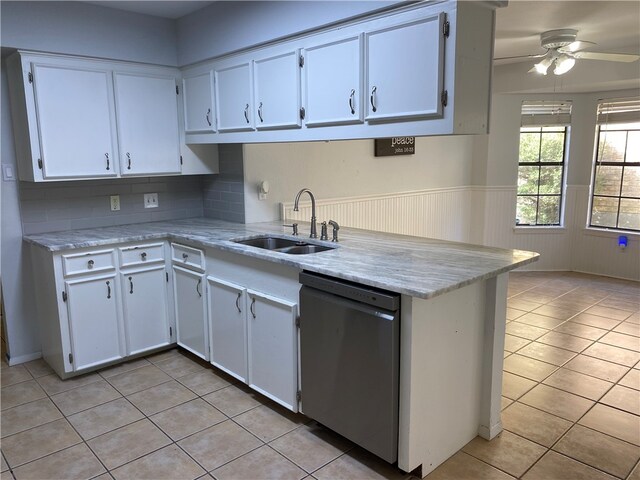 kitchen featuring white cabinets, sink, stainless steel dishwasher, ceiling fan, and light tile patterned floors