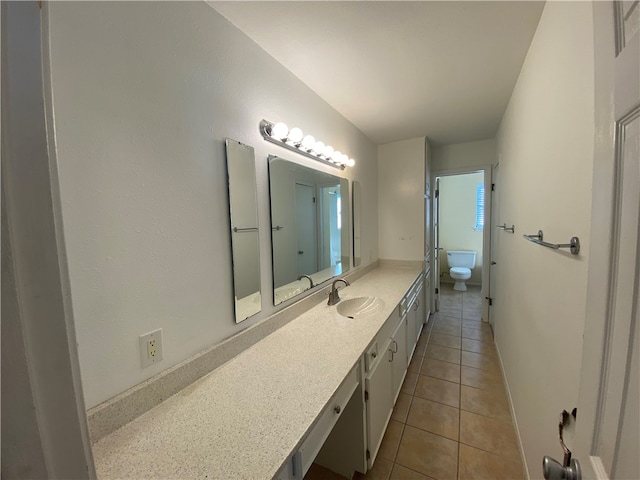 bathroom with tile patterned floors, vanity, and toilet