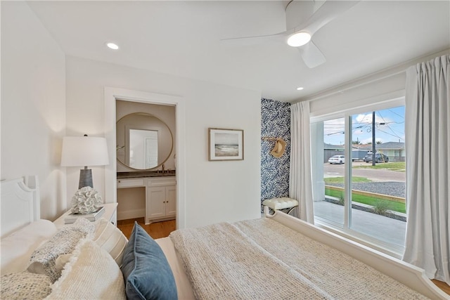 416 E Ave C Ave, Port Aransas, TX 78373 - bedroom with a sink, wood finished floors, recessed lighting, ceiling fan, and connected bathroom