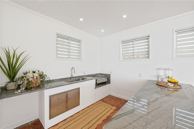 416 E Ave C Ave, Port Aransas, TX 78373 - kitchen with a sink, light tile patterned flooring, crown molding, recessed lighting, and baseboards