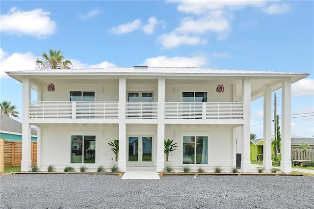 416 E Ave C Ave, Port Aransas, TX 78373 - back of property with french doors, a balcony, and stucco siding