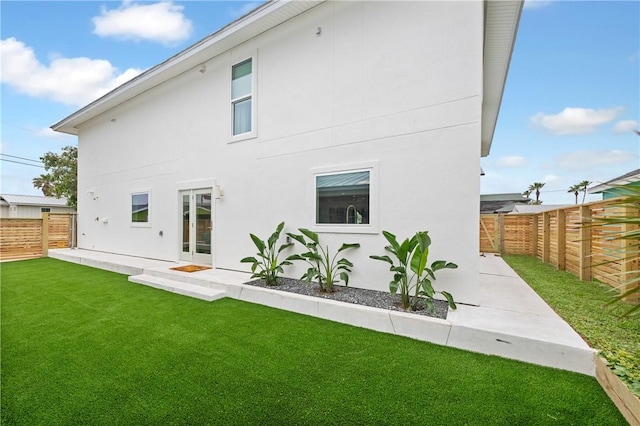 416 E Ave C Ave, Port Aransas, TX 78373 - back of property with a fenced backyard, a patio, and stucco siding