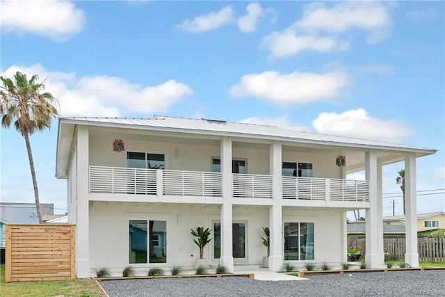 416 E Ave C Ave, Port Aransas, TX 78373 - back of house featuring stucco siding, a balcony, and metal roof