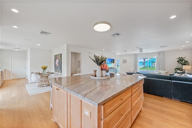 416 E Ave C Ave, Port Aransas, TX 78373 - kitchen featuring light wood-style flooring, a center island, open floor plan, light stone countertops, and recessed lighting