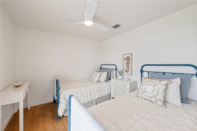 416 E Ave C Ave, Port Aransas, TX 78373 - bedroom with wood finished floors, baseboards, and ceiling fan