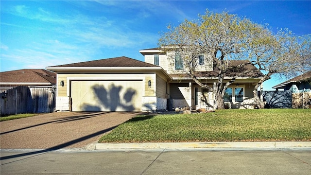 view of front of home featuring a front yard and a garage