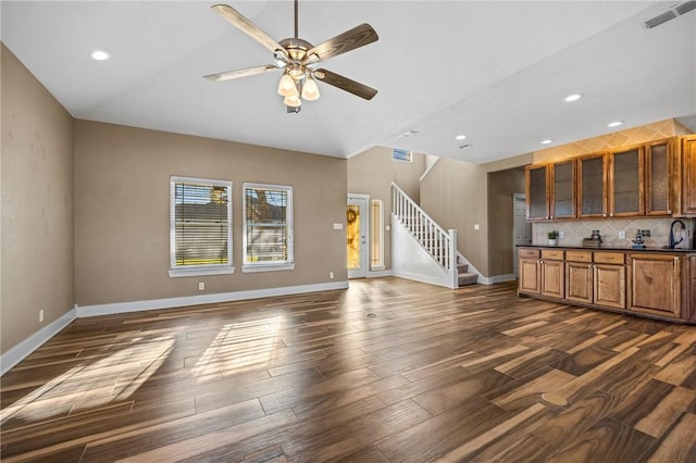 unfurnished living room with sink and ceiling fan