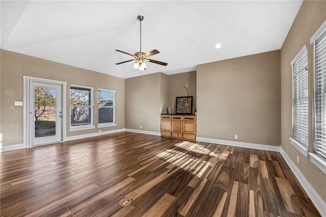 unfurnished living room featuring ceiling fan and dark hardwood / wood-style floors