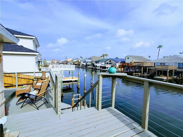 dock with a water view, a residential view, and boat lift