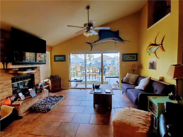 living room featuring vaulted ceiling, tile patterned flooring, ceiling fan, and a fireplace