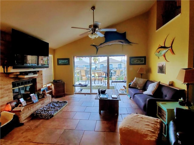 living area with ceiling fan, high vaulted ceiling, tile patterned floors, and a fireplace