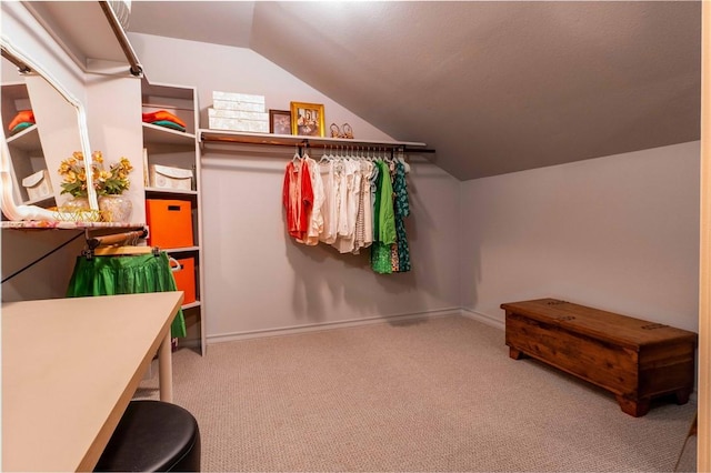 spacious closet with vaulted ceiling and carpet