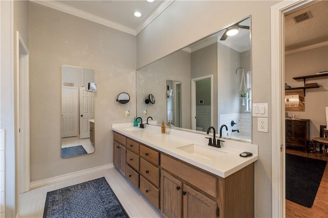 bathroom with vanity, a washtub, and crown molding