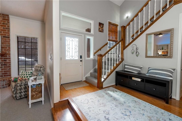 entrance foyer featuring ornamental molding and hardwood / wood-style floors