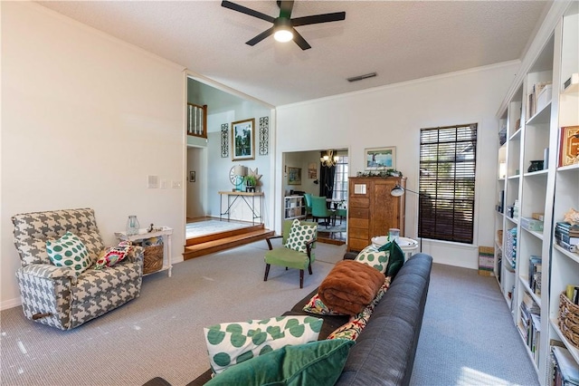 living room featuring carpet flooring, ceiling fan with notable chandelier, and a textured ceiling