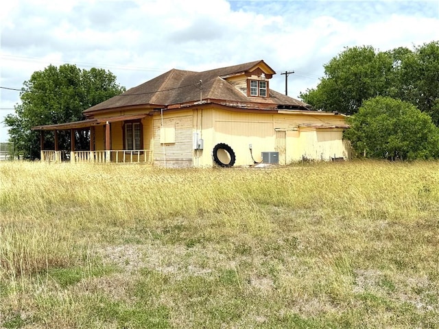 view of side of property featuring central air condition unit