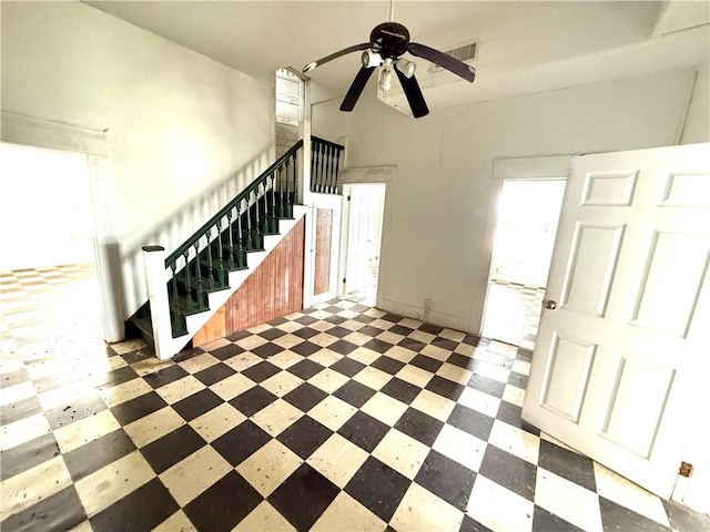 foyer with visible vents, stairs, ceiling fan, and tile patterned floors