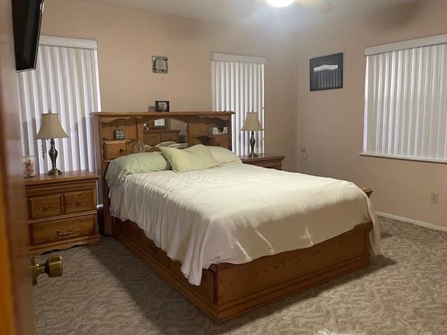 bedroom with ceiling fan and carpet floors