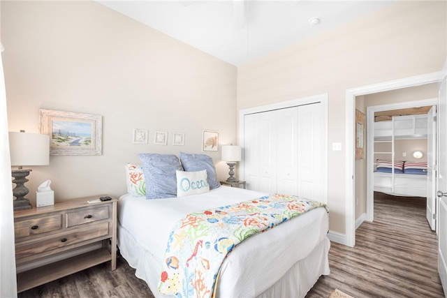 bedroom with dark wood-type flooring and a closet