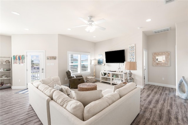 living room with ceiling fan and light hardwood / wood-style flooring