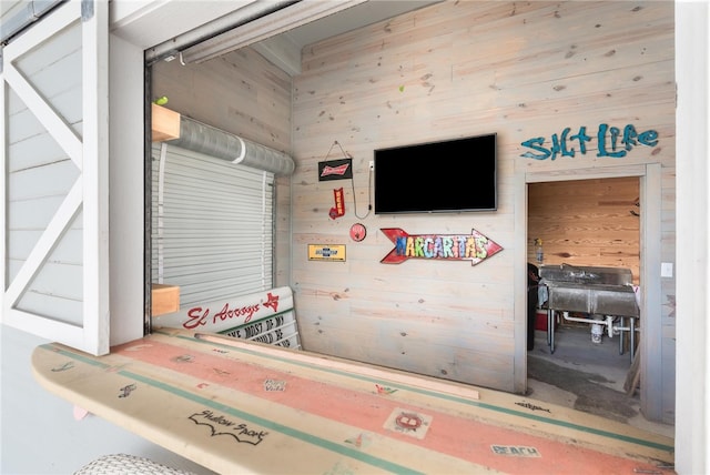 interior space featuring concrete flooring and wooden walls