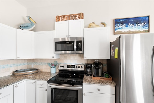 kitchen with white cabinetry, decorative backsplash, light stone counters, and stainless steel appliances