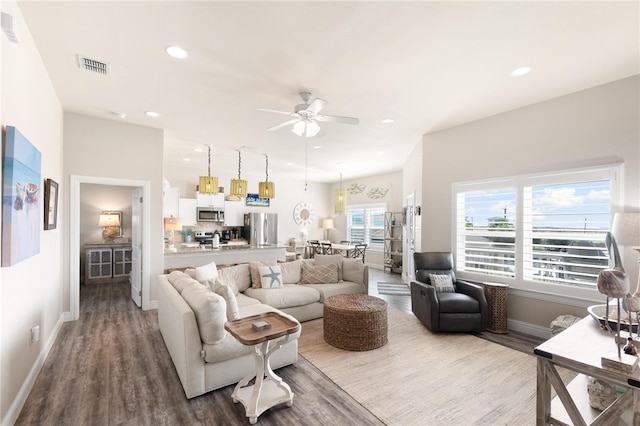 living room with hardwood / wood-style flooring and ceiling fan