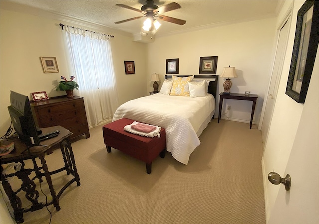 bedroom with ornamental molding, light carpet, and ceiling fan