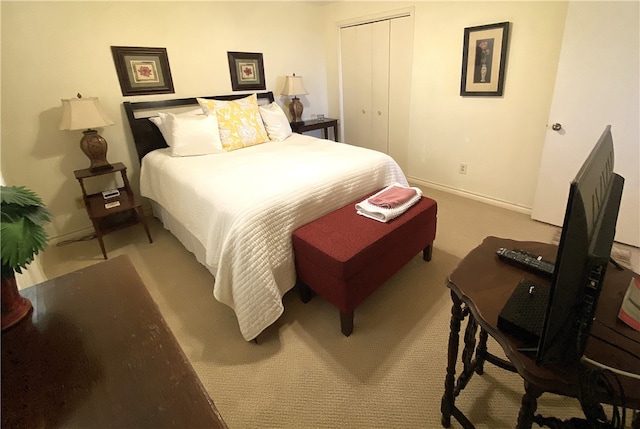 bedroom featuring light colored carpet and a closet