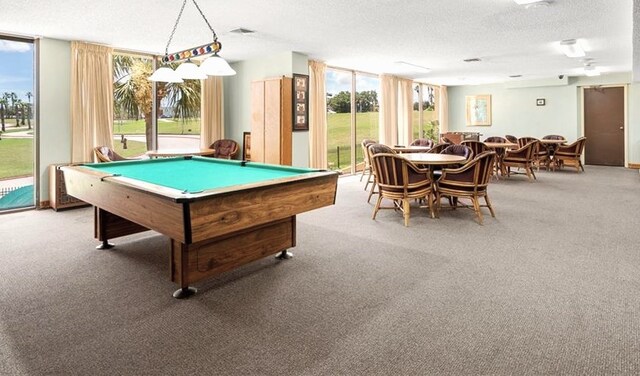 recreation room with pool table, a textured ceiling, and plenty of natural light