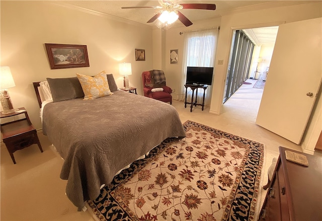 bedroom with ceiling fan, carpet flooring, and crown molding