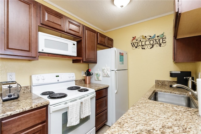 kitchen featuring ornamental molding, a textured ceiling, light stone countertops, sink, and white appliances