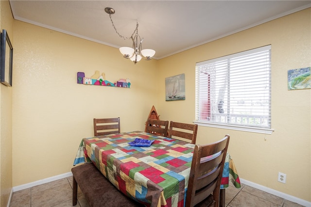 tiled dining area with crown molding and an inviting chandelier